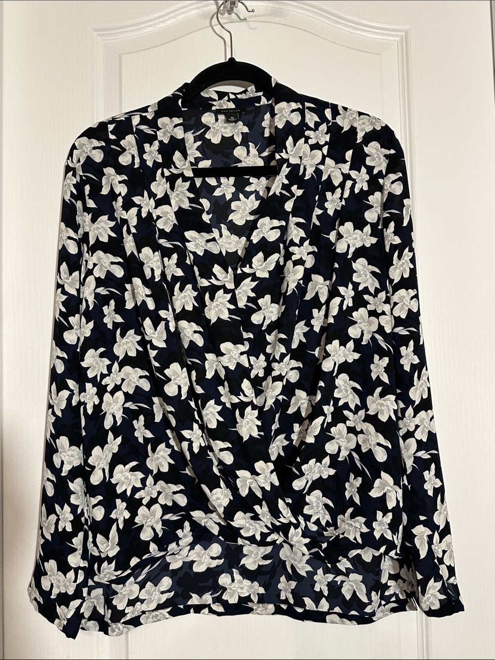 Ann Taylor navy blue long-sleeve top featuring a white floral pattern
